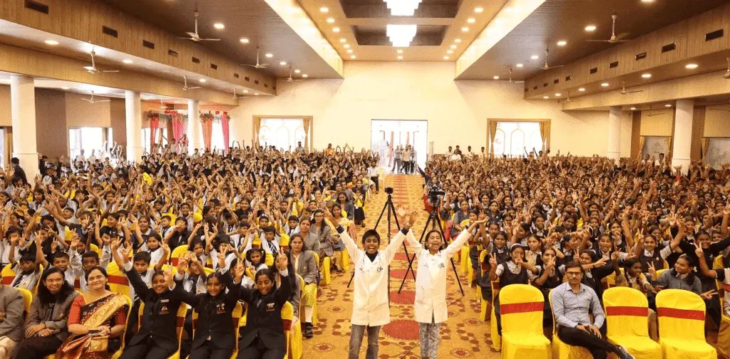 Jainam Jain engaging with audience during a business event